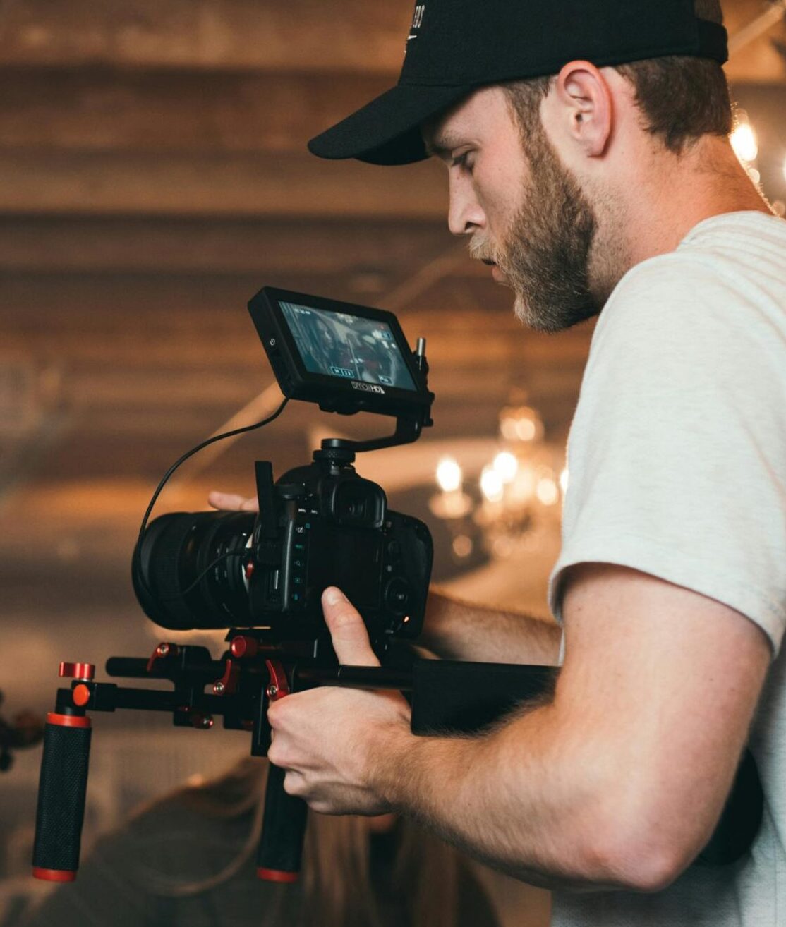 A filmmaker capturing a violinist on set, highlighting video production.
